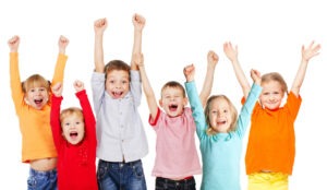 Happiness group children with their hands up isolated on white